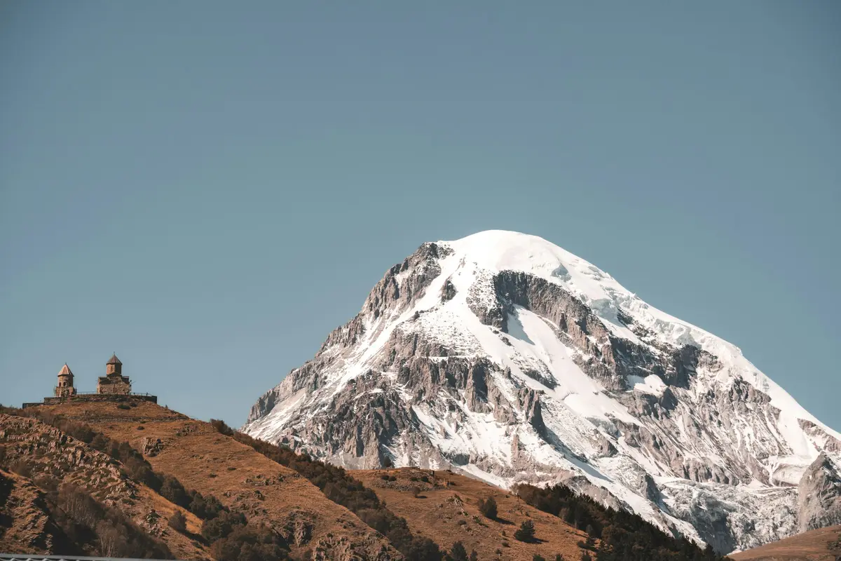 Gergeti Trinity Church with a snow-capped mountain behind, Kazbegi, Georgia