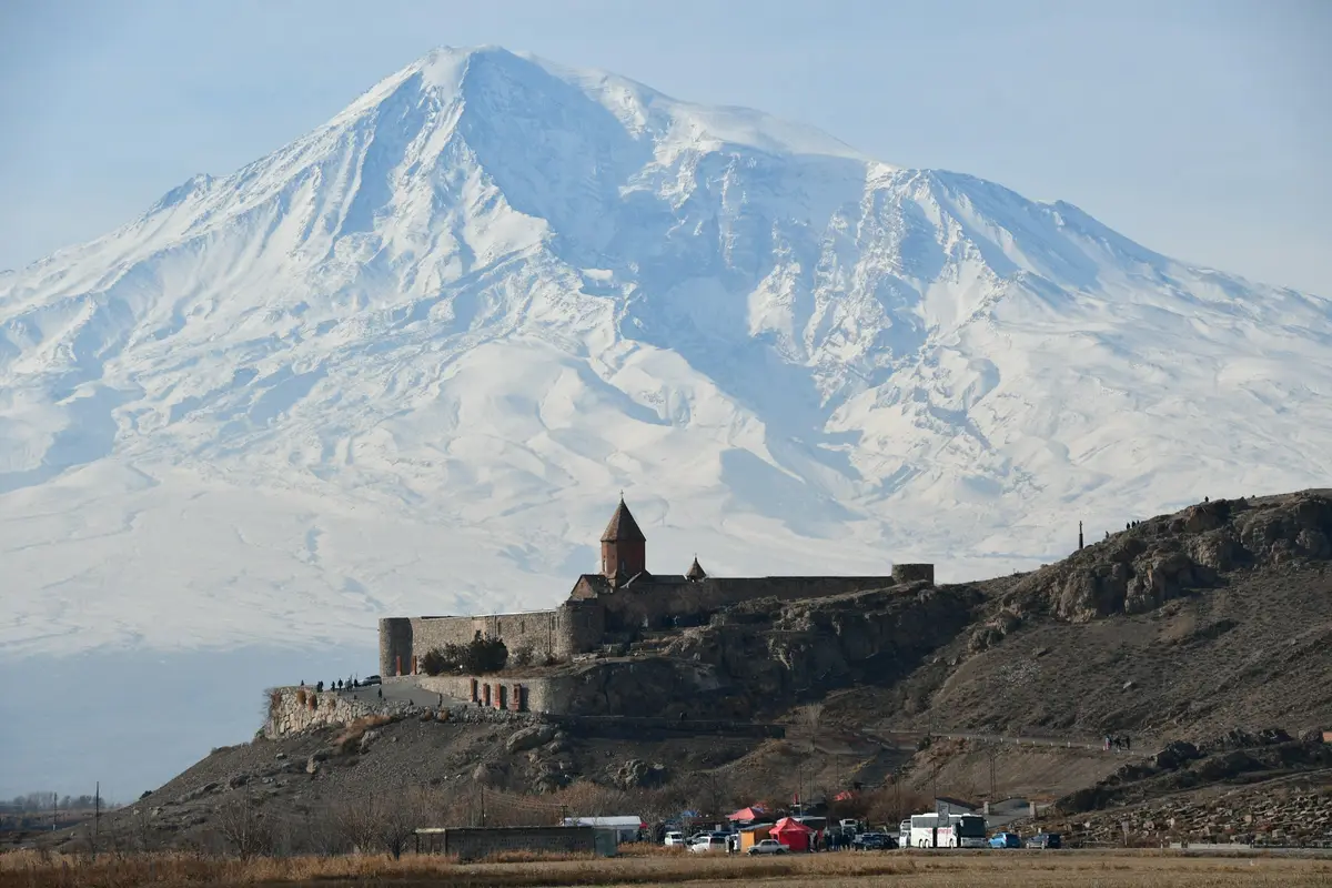 Khor Virap monastery on a hill with snow-covered Mount Ararat behind, Armenia