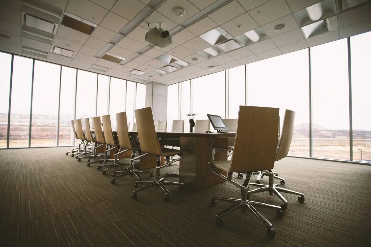 A boardroom with a wooden conference table and chairs